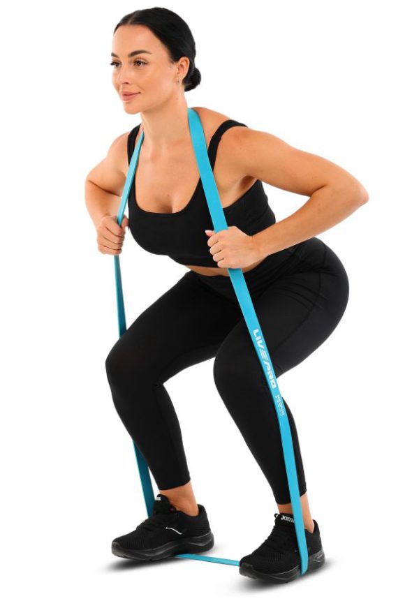 Woman squatting with a blue band from the LivePro power band set