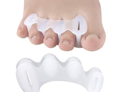 Silicone toe spacers, one fitted between the toes of a bare foot